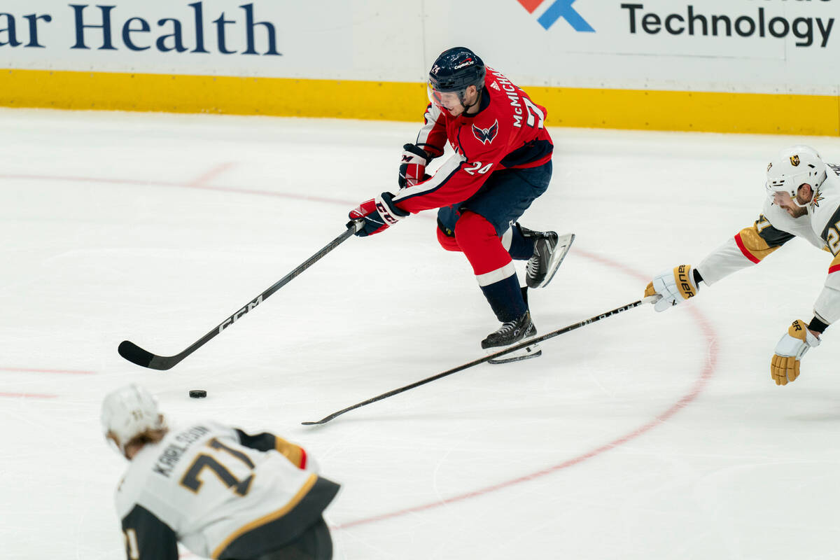 Washington Capitals center Connor McMichael (24) advances past Vegas Golden Knights center Will ...