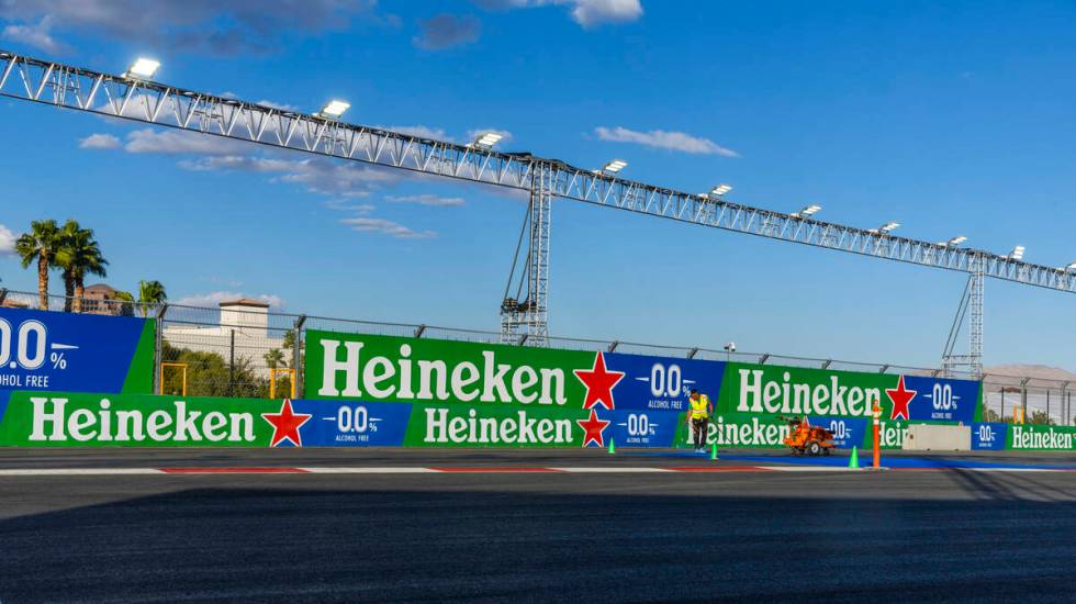 Turn one is painted with a logo about the Formula One Las Vegas Grand Prix pit building on Tues ...