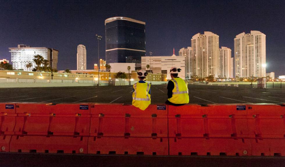 Gino Catania, left, and his cousin Vinny Catania wait on a barrier for the implosion of the rem ...