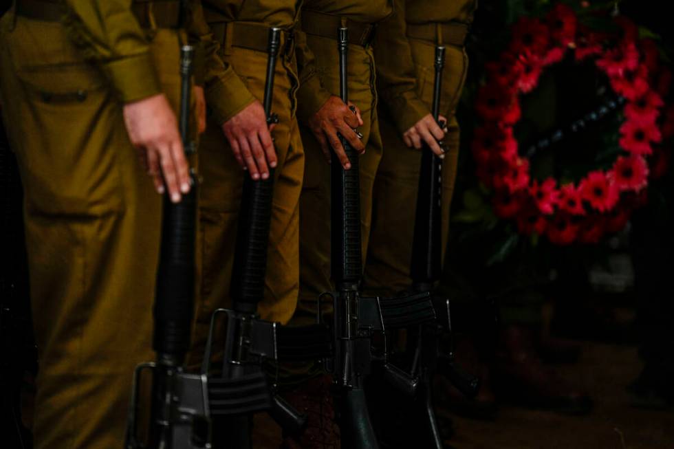 Israeli honor guard soldiers attend the funeral of Israeli reserve soldier Master sergeant Raz ...