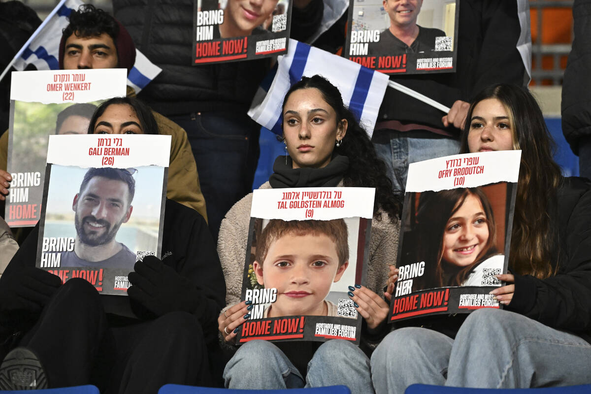 Fans of Israel hold up signs of people who were kidnapped by Hamas prior the start of the Euro ...