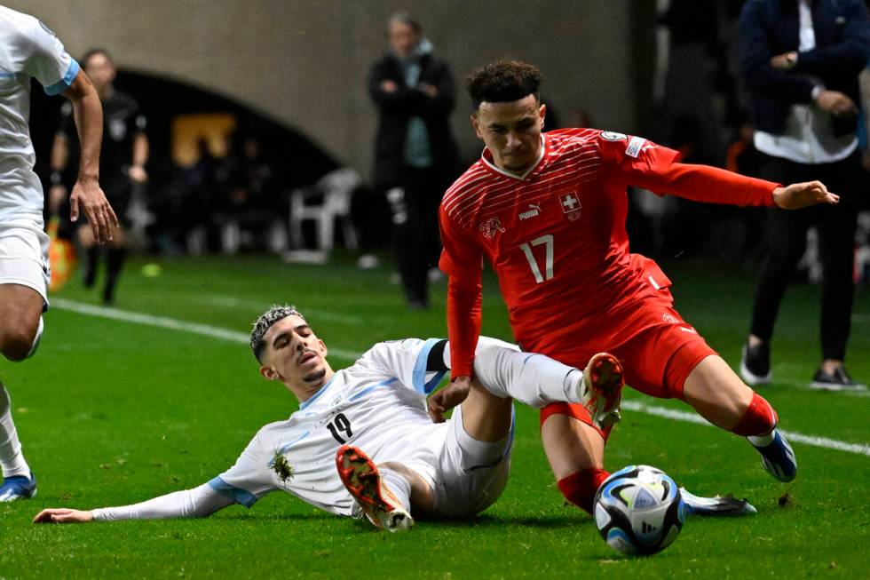 Israel's Dor Turgeman, left, challenges Switzerland's Ruben Vargas during the Euro 2024 group I ...