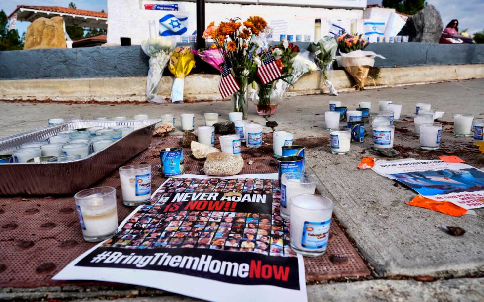 Flowers and candles are left at a makeshift shrine placed at the scene of a Sunday confrontatio ...