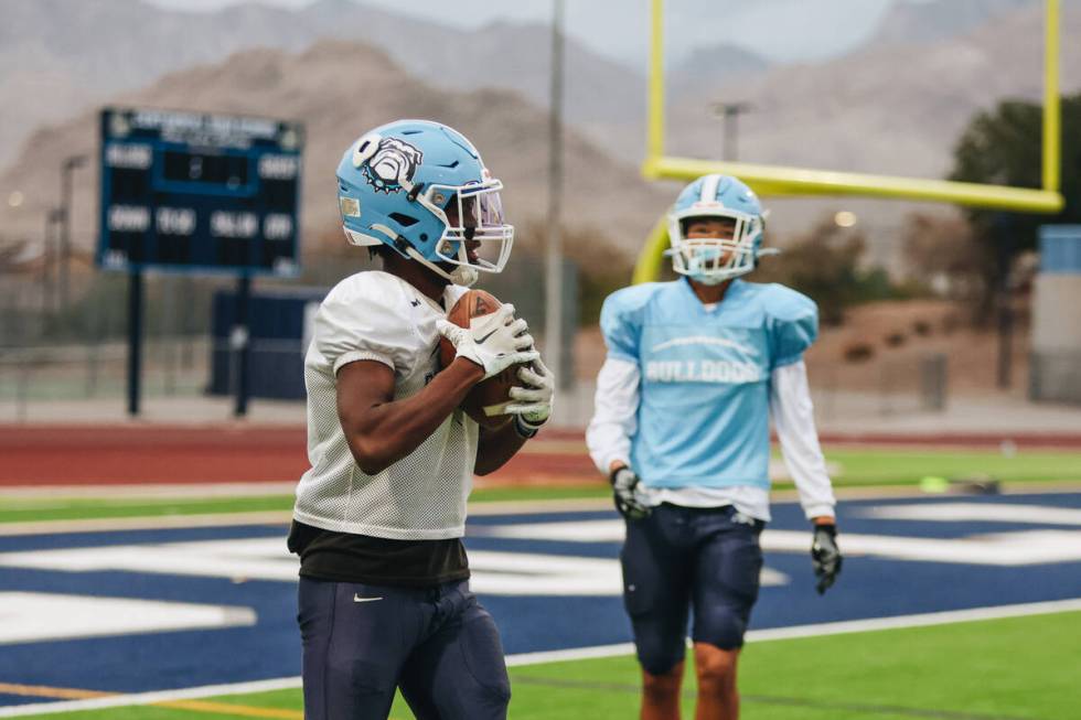 Centennial football players participate in a team practice at Centennial High School on Wednesd ...