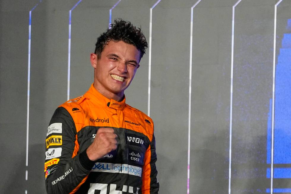 Third placed McLaren driver Lando Norris of Britain celebrates on the podium after the Qatar Fo ...