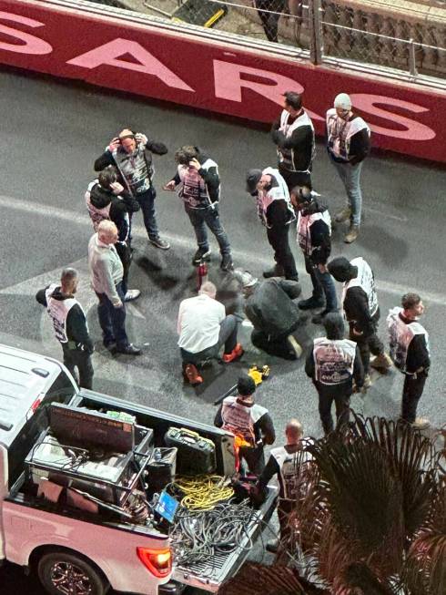 Crews are seen working on the track problem caused by an issue with a drain cover at the first ...