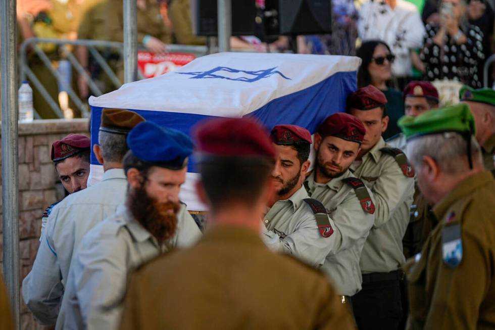 Israeli soldiers carry the flag-draped casket of Israeli soldier Capt. Shlomo Ben Nun, during h ...