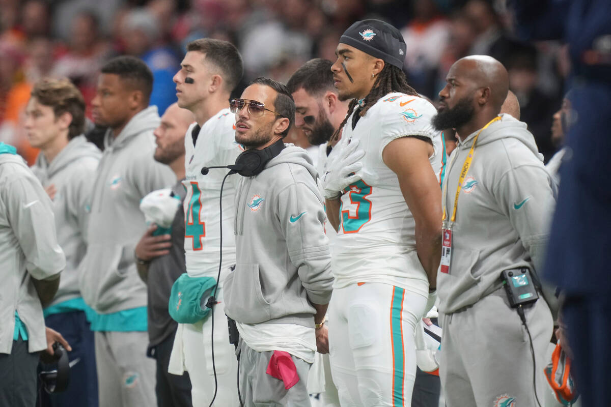 Miami Dolphins head coach Mike McDaniel pauses with his team before the start of an NFL footbal ...