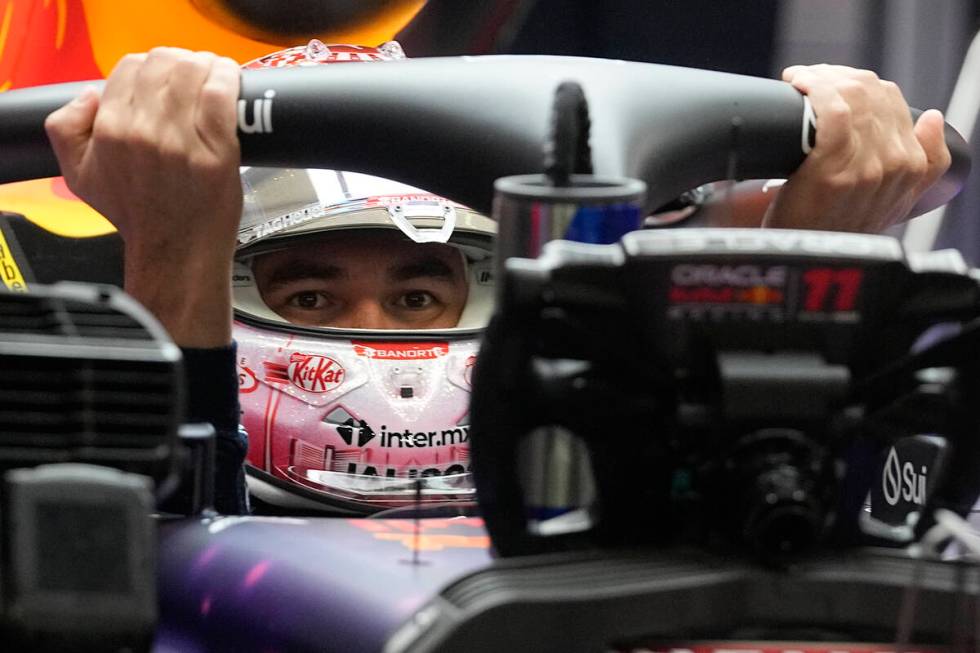 Red Bull driver Sergio Perez, of Mexico, gets into his car during the final practice session fo ...