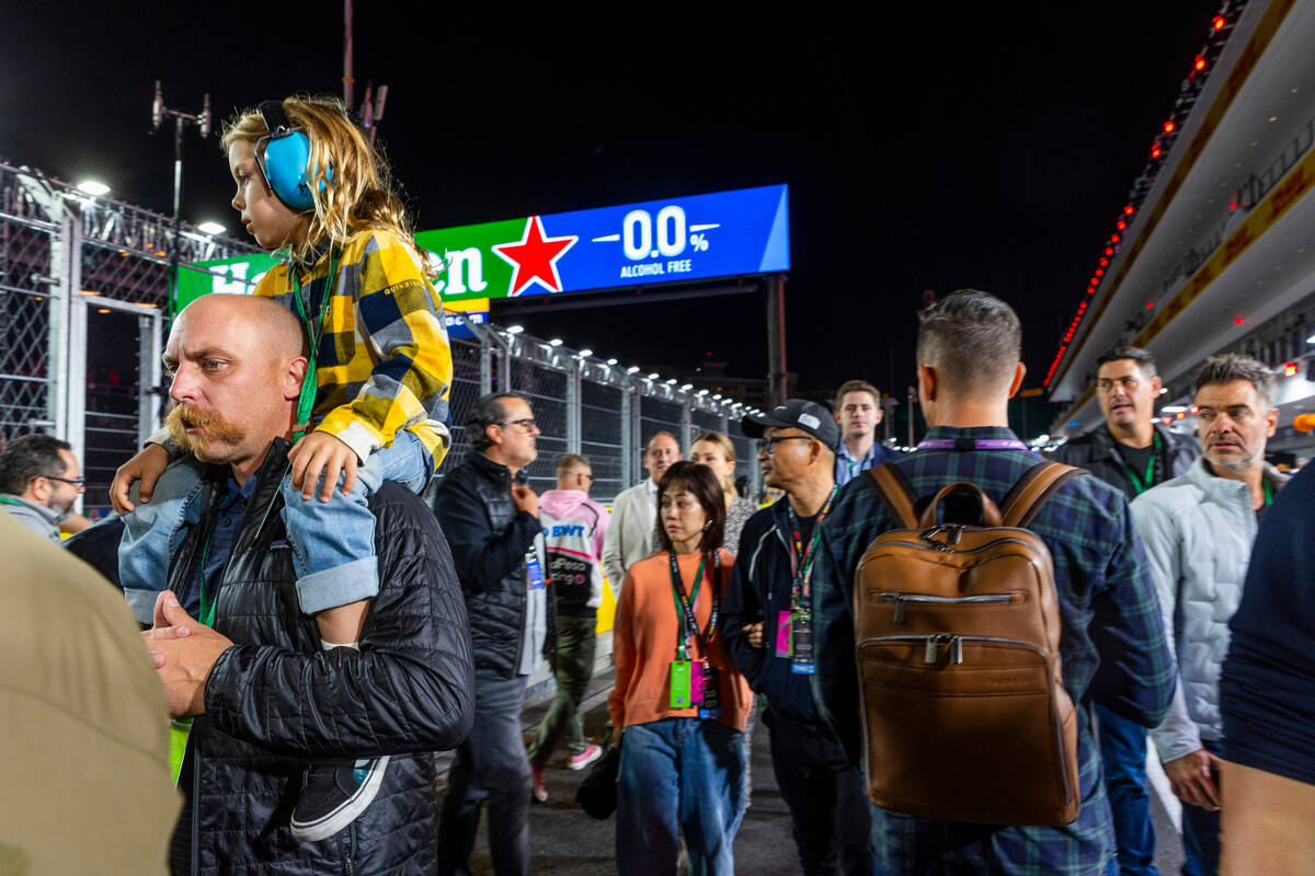 Fans wander about pit building on the first practice run during the opening night of the Las Ve ...