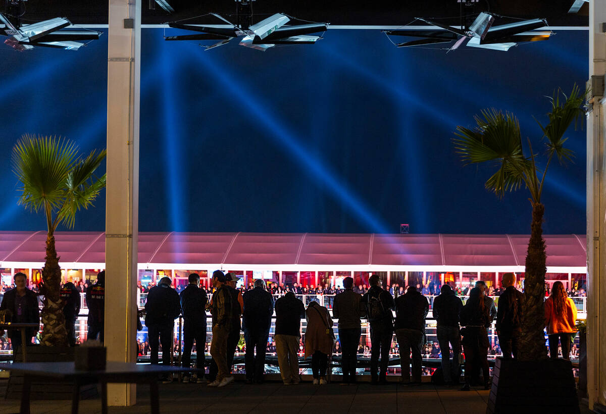 Racing fans watch the qualifying session from the rooftop of the paddock on the second night of ...