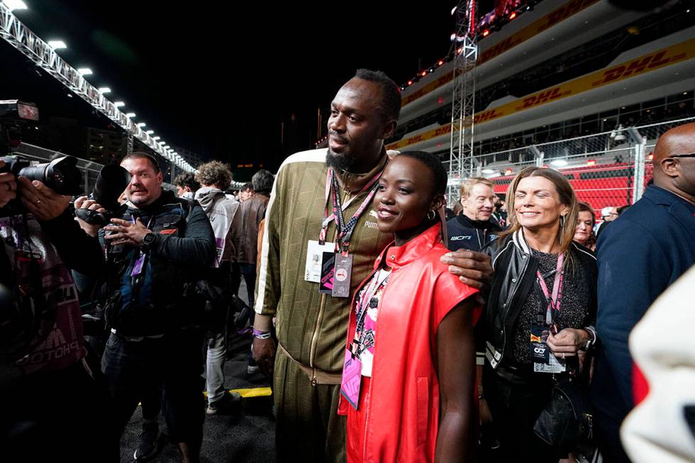 Usain Bolt poses for photos with actor Lupita Nyong'o at the Formula One Las Vegas Grand Prix a ...