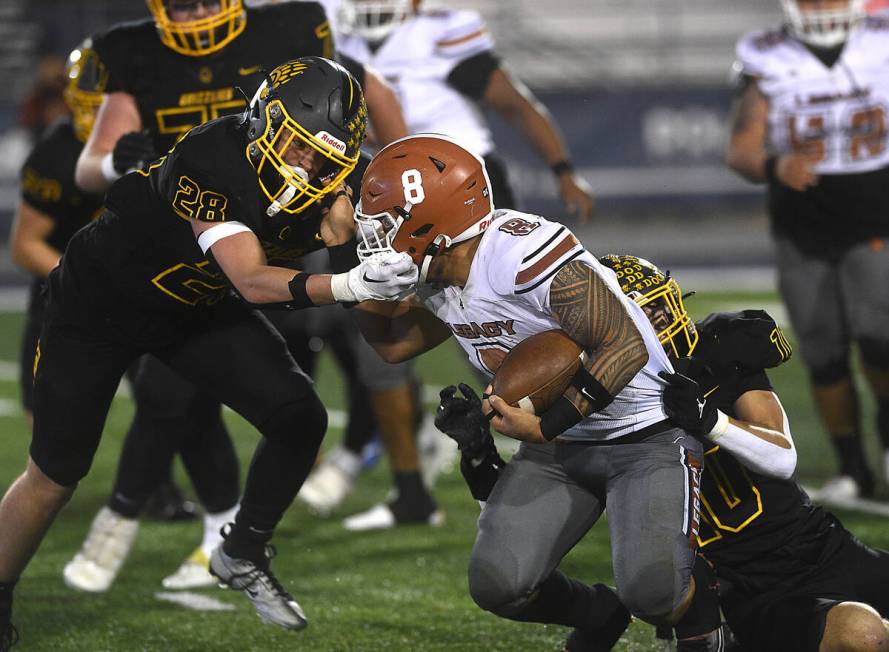 Legacy’s Phoenix Jennings gets his face mask grabbed by Galena’s Ever Whitaker during their ...