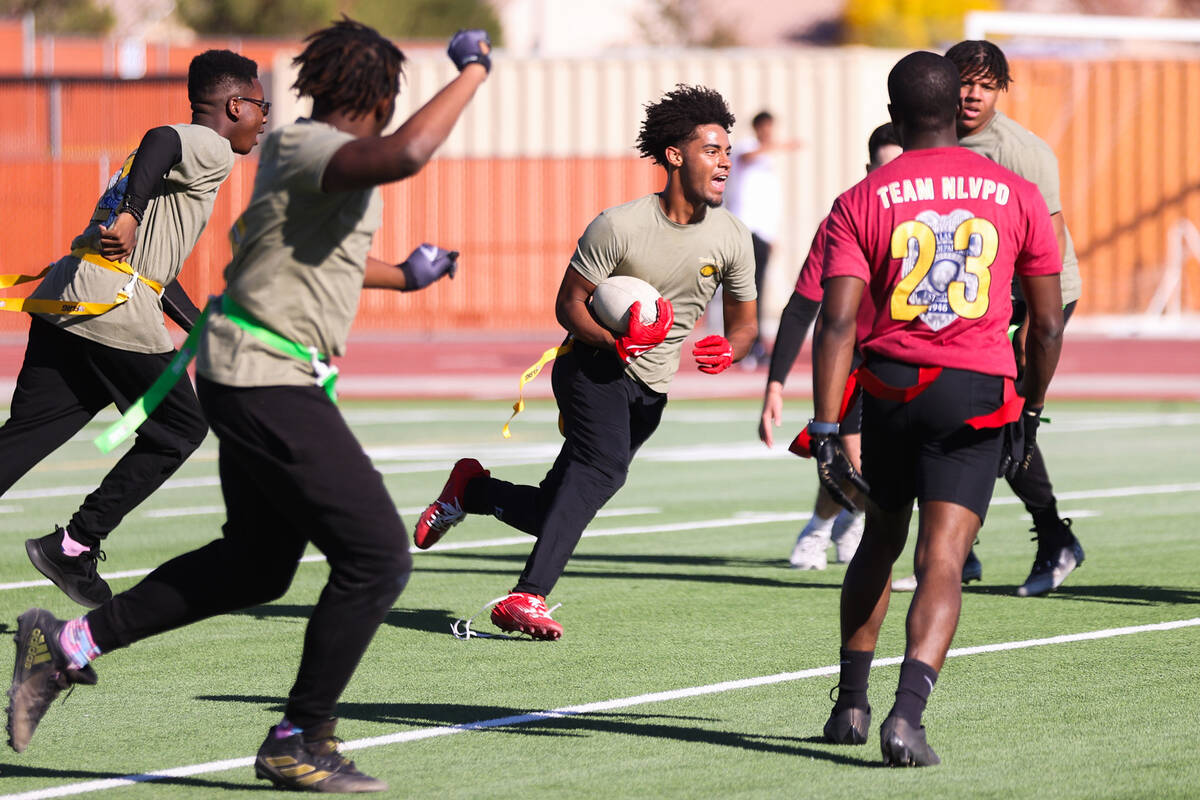 Marquesion Floyde, a Coronado High School student, is cheered on by his teammates after interce ...