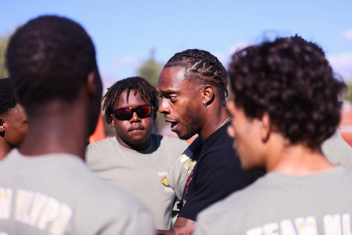 Retired NFL player Brandon Marshall coaches the high school team during the third annual Turkey ...