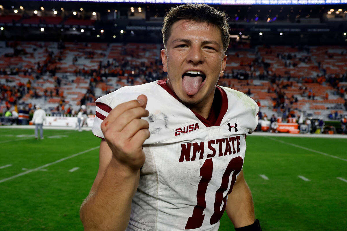 New Mexico State quarterback Diego Pavia celebrates after a win over Auburn after an NCAA colle ...