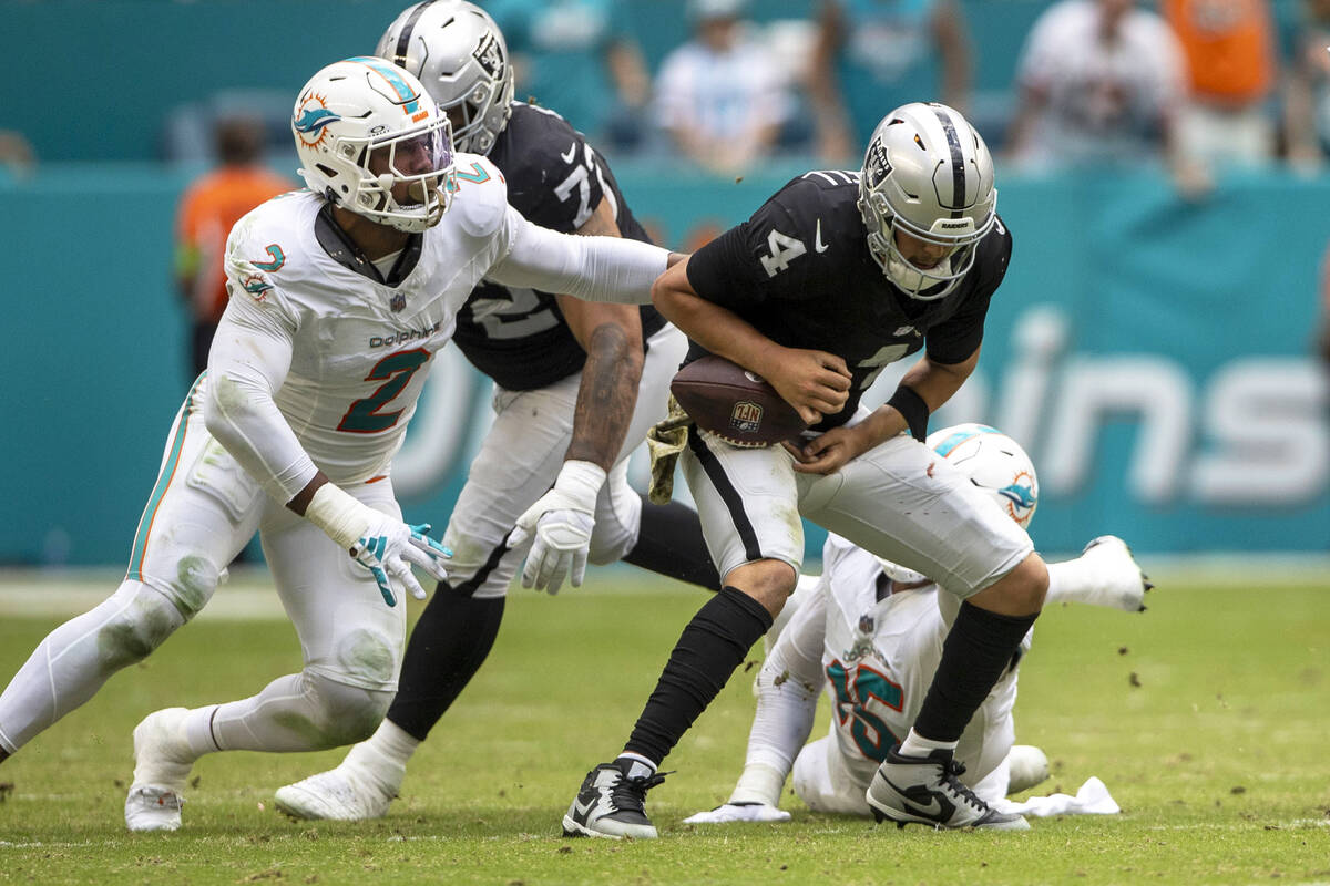 Raiders quarterback Aidan O'Connell (4) loses control of the football as he is tackled by Miami ...