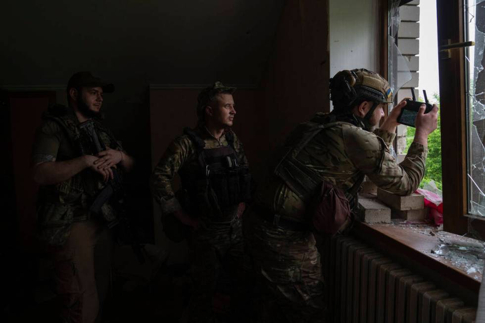 An officer of Ukraine's 59th Motorized Brigade controls a drone from a shelter in the suburbs o ...