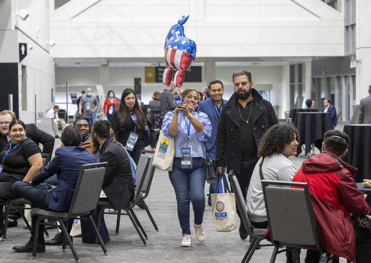 Delegate Margarita Darrett-Quiroz walks with a donkey balloon through the SAFE Credit Union Con ...