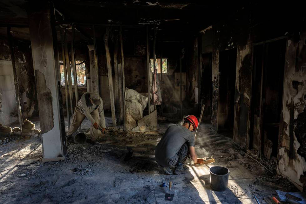 Members of Israel's Antiquities Authority try to find items that will help identify people kill ...