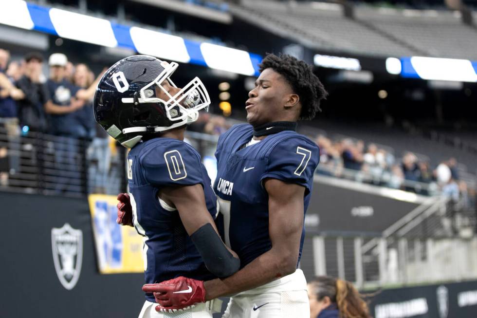 Lake Mead’s Antonio Spann (0) celebrates his touchdown with Jeremiah Turner (7) during t ...