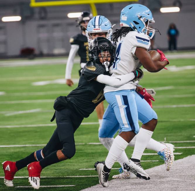 Centennial running back Khyren Harris (14) is pushed off the field with the ball during a class ...