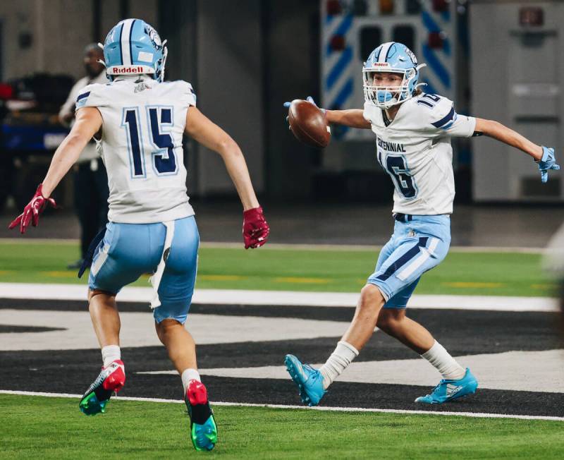 Centennial wide receiver Logan Weimer (16) celebrates a touchdown with teammate Mason Garza (15 ...