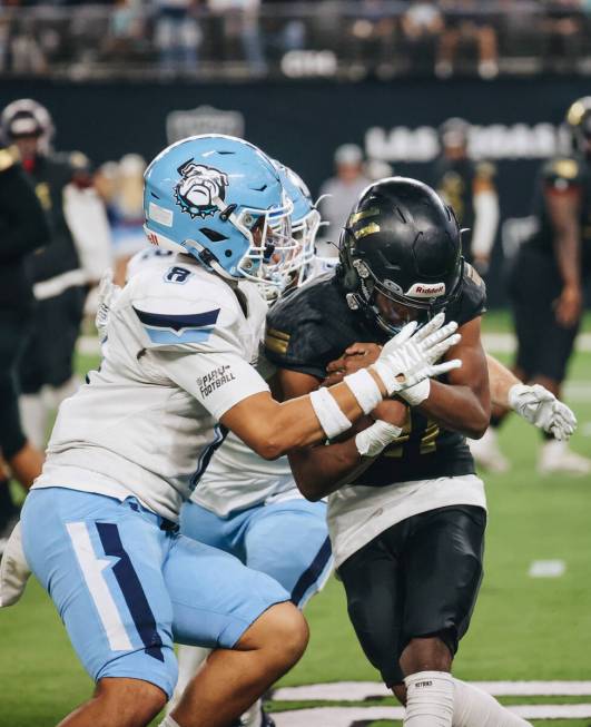 Sunrise Mountain quarterback Christein Thompson (11) keeps the ball in his clutch as Centennial ...