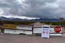 Several warning devices indicate that Titus Canyon Road is closed in Death Valley National Park ...