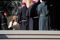 Pope Francis smiles as he meets prelates during his weekly general audience in St. Peter's Squa ...