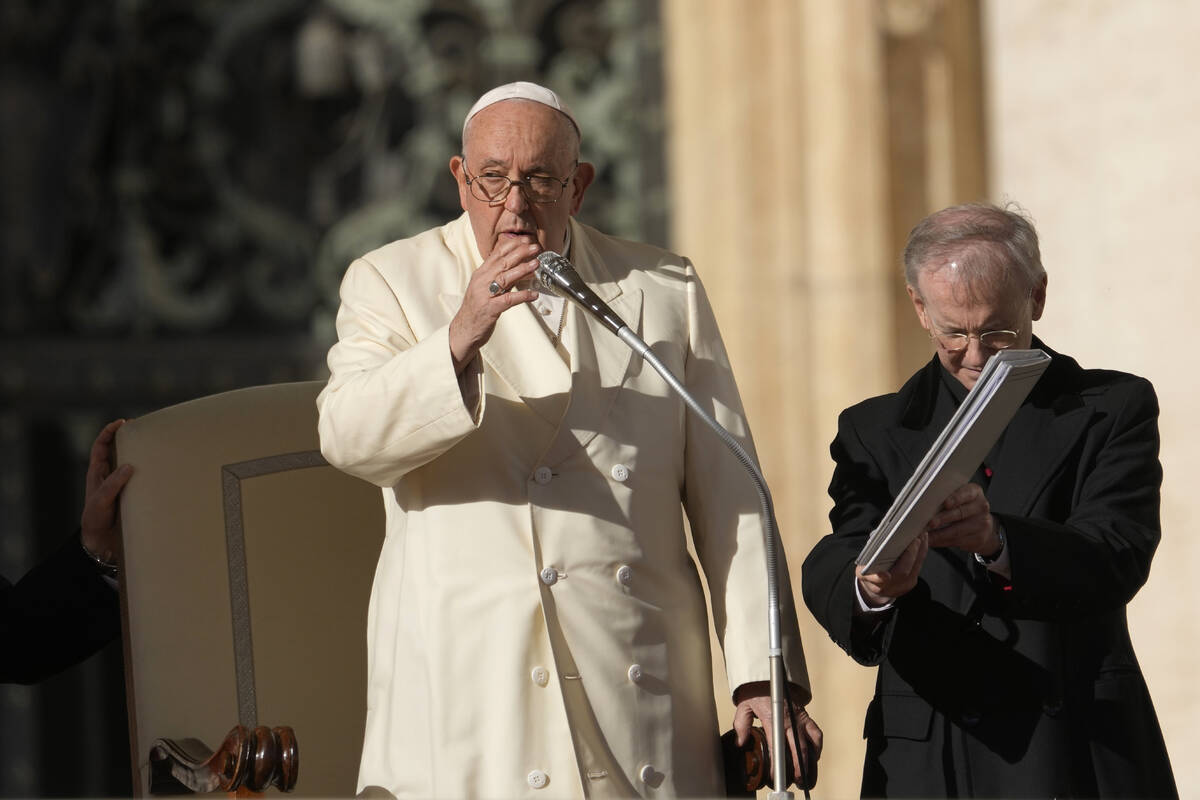 Pope Francis gives his blessing during his weekly general audience in St. Peter's Square, at th ...