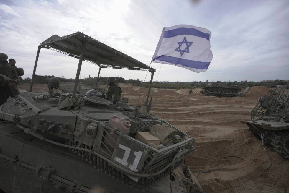 Israeli soldiers are seen during a ground operation in the Gaza Strip, Wednesday, Nov. 22, 2023 ...