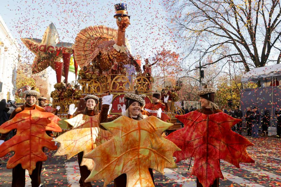 Parade performers lead the Tom Turkey float down Central Park West at the start of the Macy's T ...