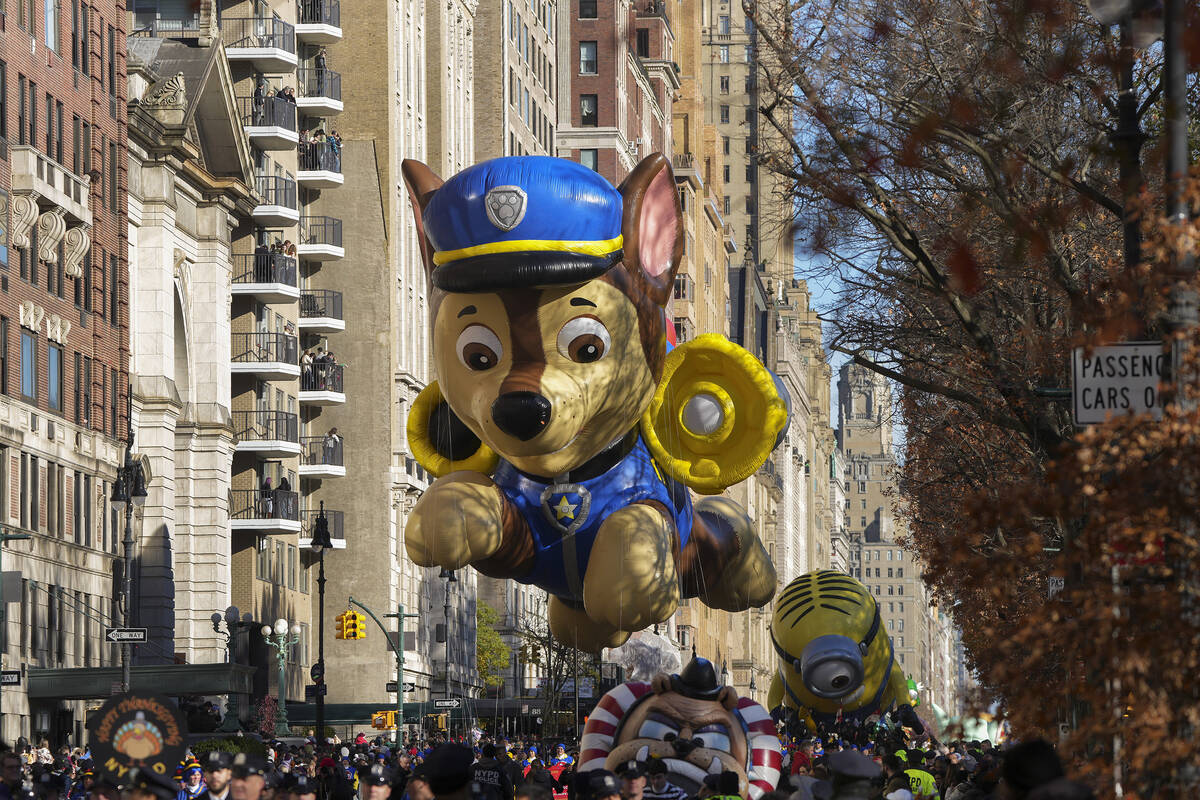 The handlers guide the Paw Patrol balloon along Central Park West during the Macy's Thanksgivin ...