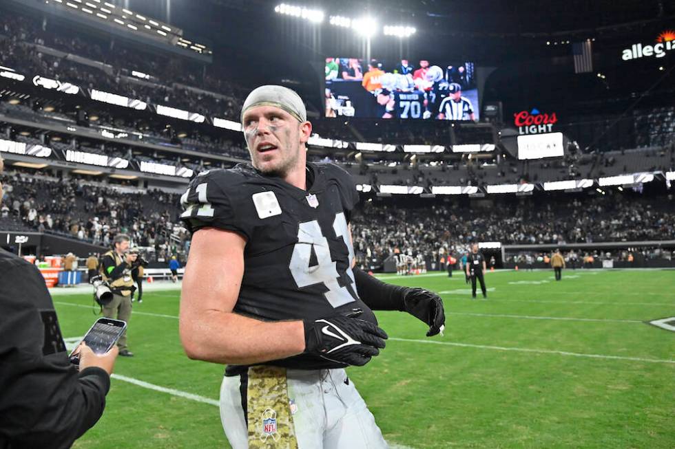 Las Vegas Raiders linebacker Robert Spillane heads off the field following an NFL football game ...