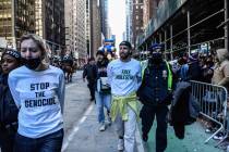 Pro-Palestinian protesters are detained during Macy's annual Thanksgiving Day Parade on Nov. 23 ...