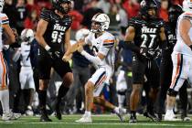 Virginia quarterback Anthony Colandrea, center, gestures after running for a first down during ...