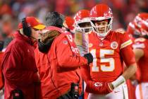 Kansas City Chiefs quarterback Patrick Mahomes (15) meets with offensive coordinator Matt Nagy, ...