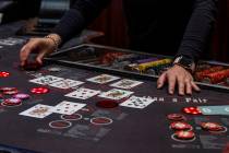 A dealer works the table as guests play Ultimate Texas Hold’Em at Red Rock Casino on Tuesday, ...