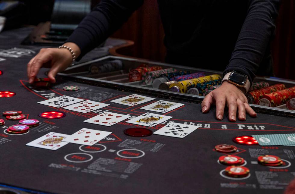 A dealer works the table as guests play Ultimate Texas Hold’Em at Red Rock Casino on Tuesday, ...