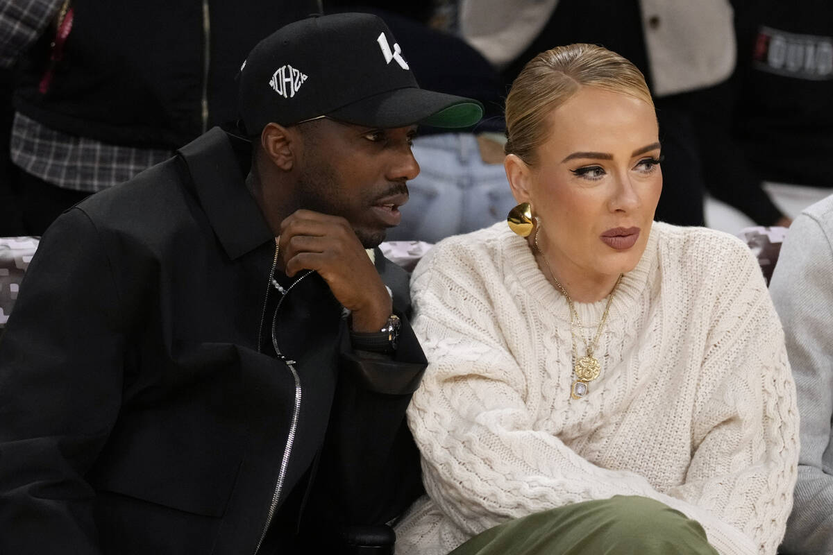 Singer Adele sits with Rich Paul during an NBA basketball game between the Los Angeles Lakers a ...