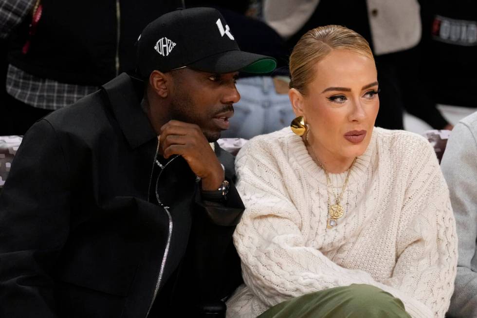 Singer Adele sits with Rich Paul during an NBA basketball game between the Los Angeles Lakers a ...