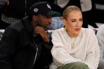 Singer Adele, right, talks to Rich Paul during the first half of an NBA basketball game between ...