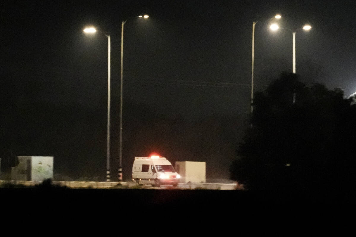 An Israeli ambulance is seen leaving the Kerem Shalom crossing between Israel and Gaza, in Isra ...