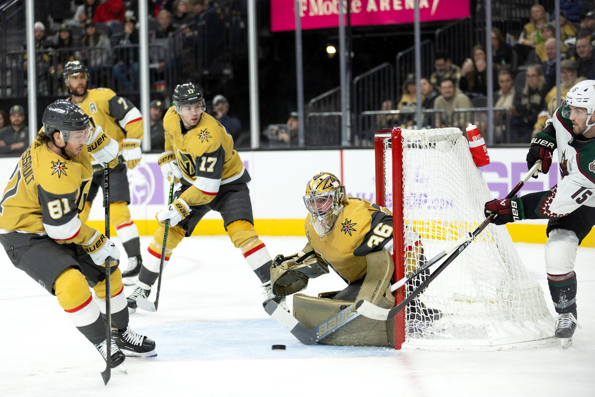 Golden Knights goaltender Logan Thompson (36) monitors the puck while Coyotes center Alexander ...