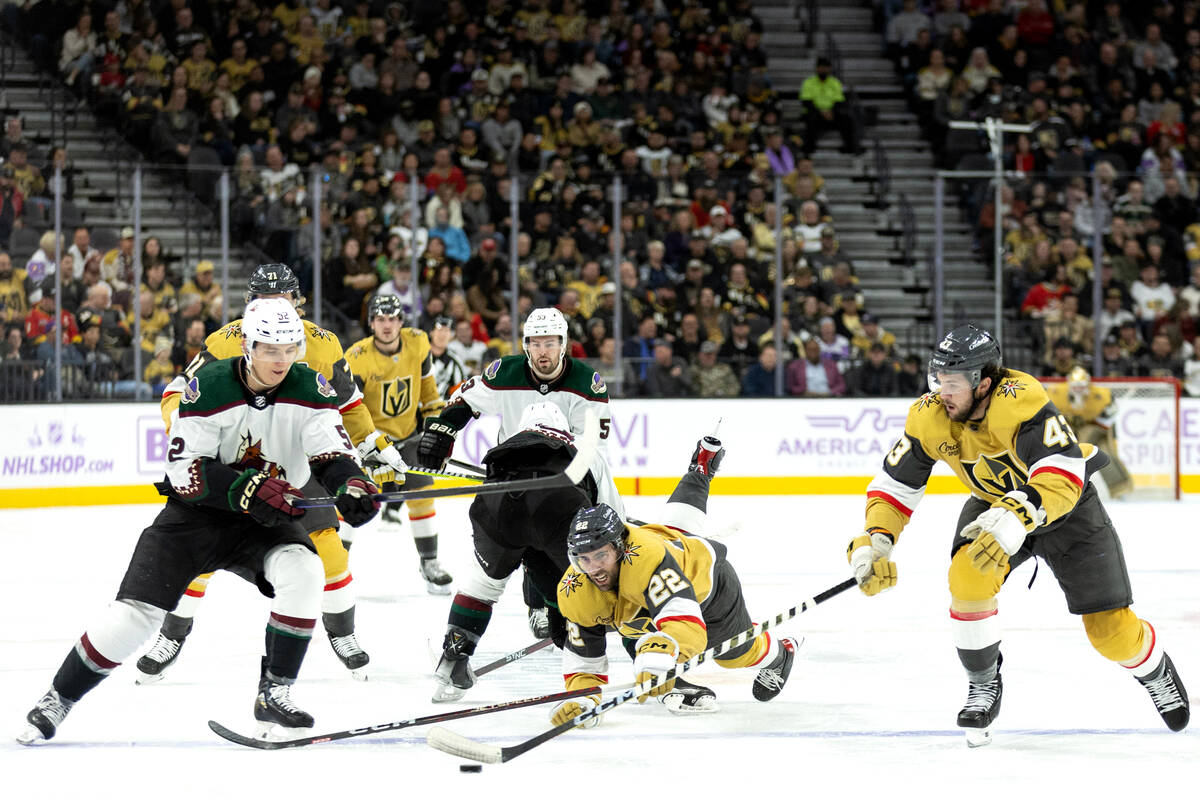 Golden Knights right wing Michael Amadio (22) dives toward the action while Coyotes defenseman ...