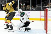 Golden Knights right wing Keegan Kolesar (55) battles at the net while Coyotes goaltender Conno ...