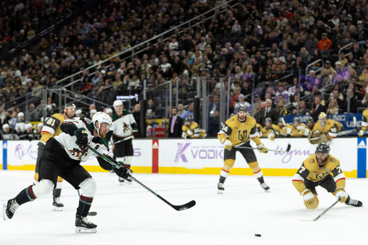 Coyotes left wing Lawson Crouse (67) shoots an empty-net goal during the third period of an NHL ...