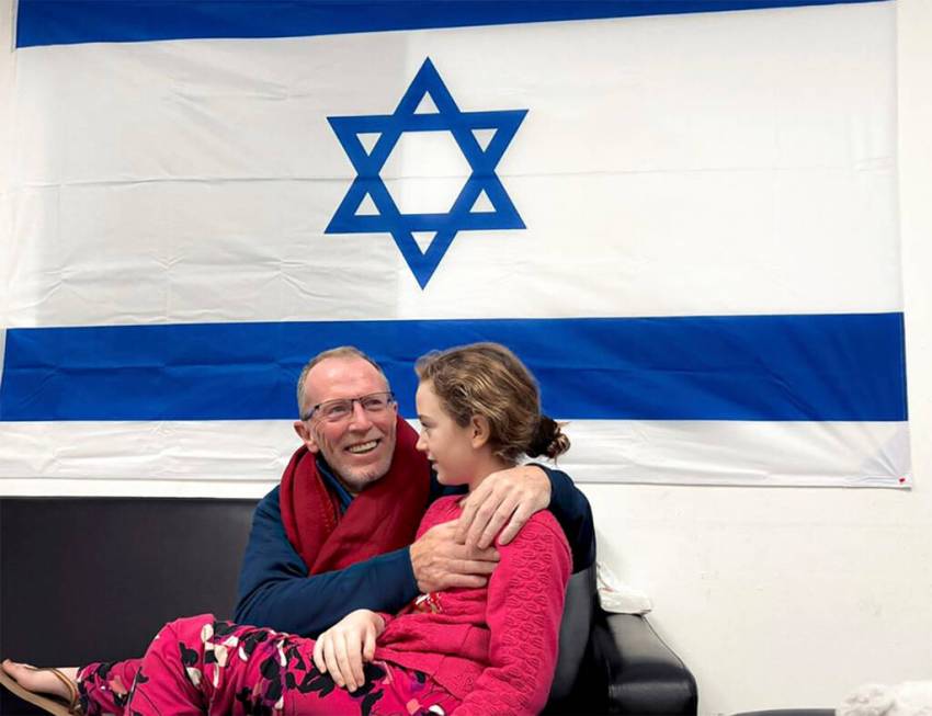 In this photo provided by the Israeli Army, Emily Hand, a released hostage, reunites with her f ...