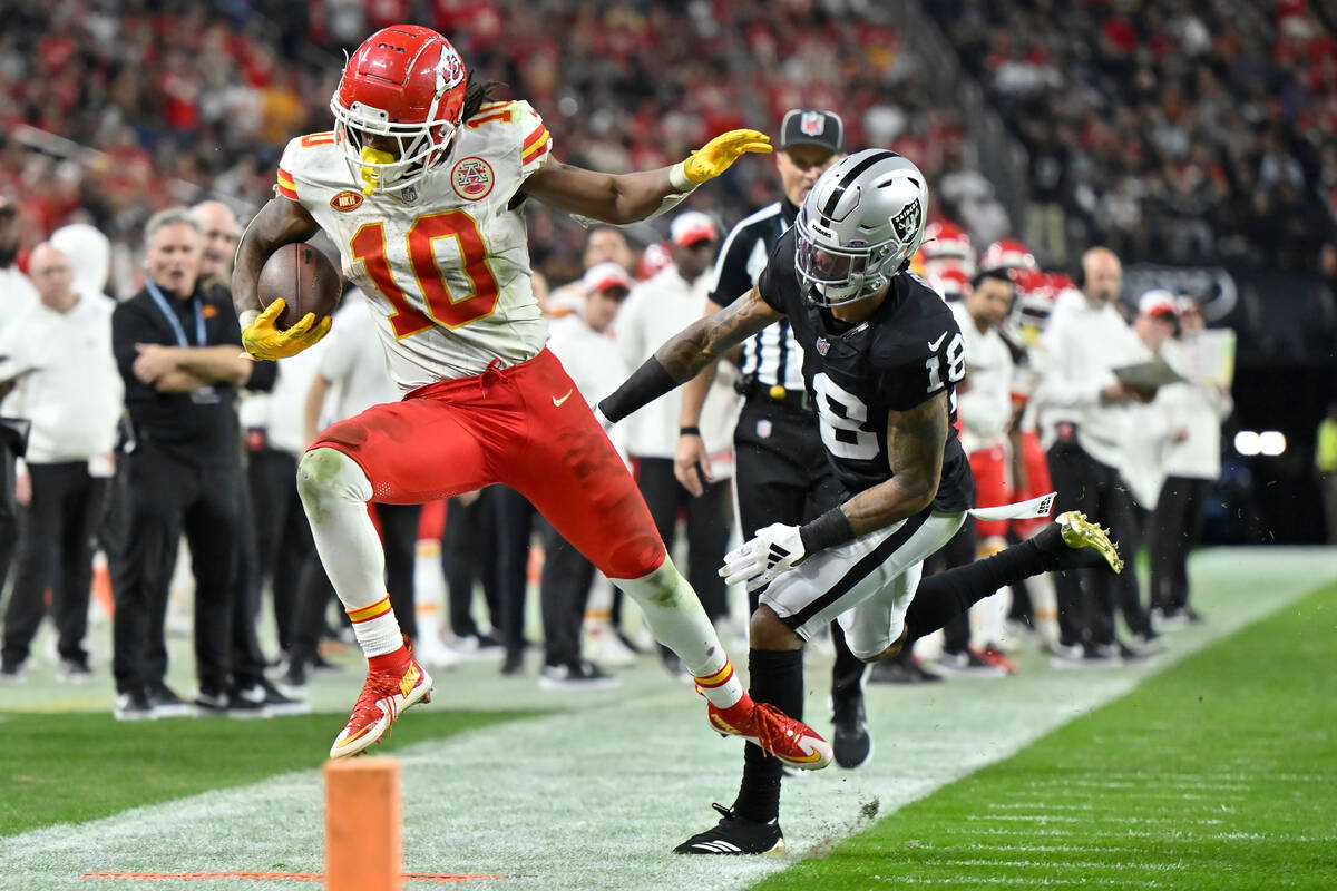 Kansas City Chiefs running back Isiah Pacheco (10) is pushed out of bounds by Las Vegas Raiders ...